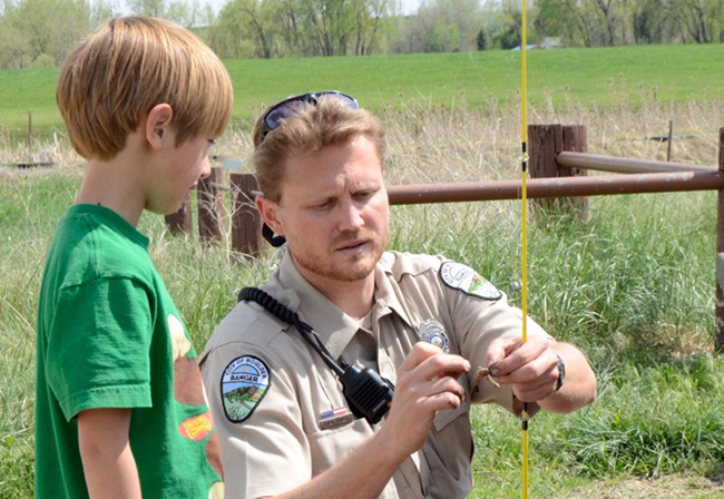 Ranger helping child fish