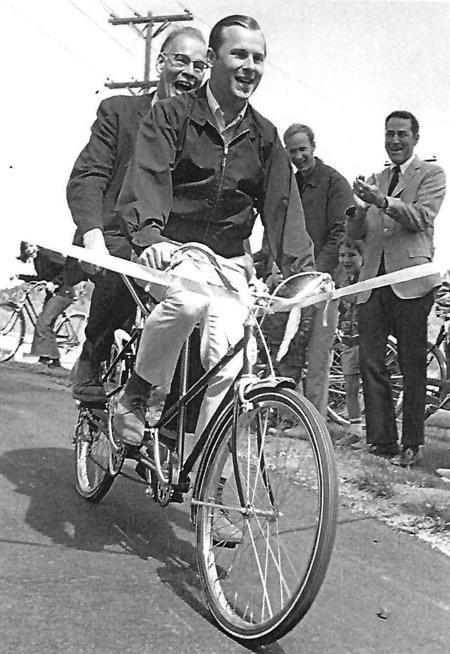 Two men on a tandem bike to celebrate the opening of a new bikeway in 1970