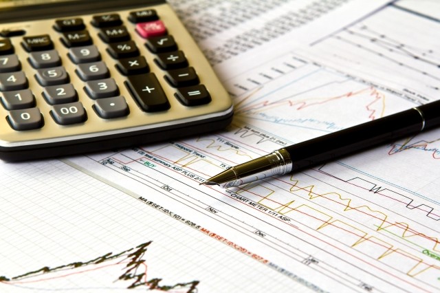 Calculator and Paperwork with Pen on Table