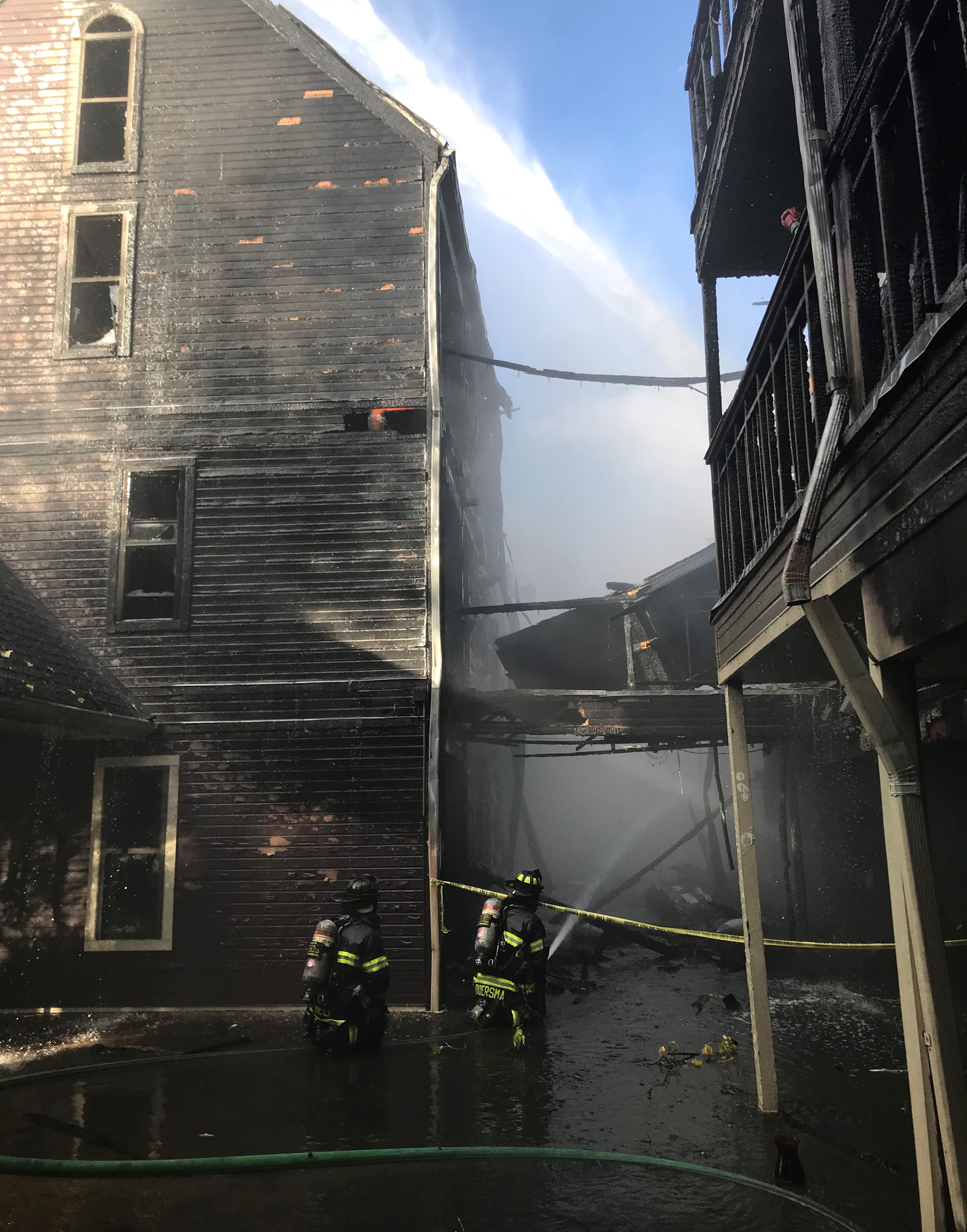 Firefighters extinguishing fire at apartment complex