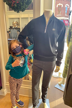 Small Business Saturday child posing with mannequin 