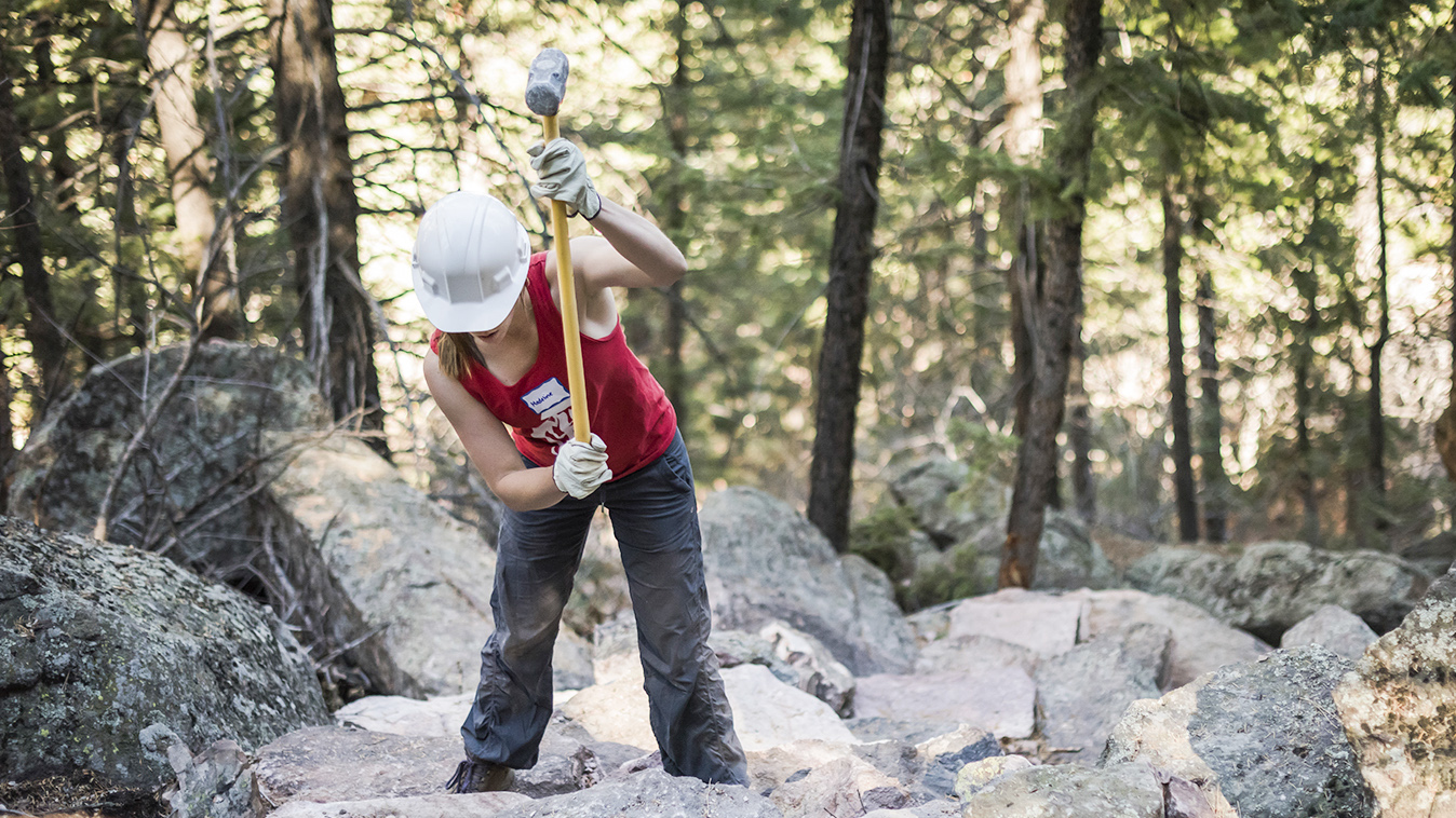An OSMP volunteer works on the Royal Arch Trail