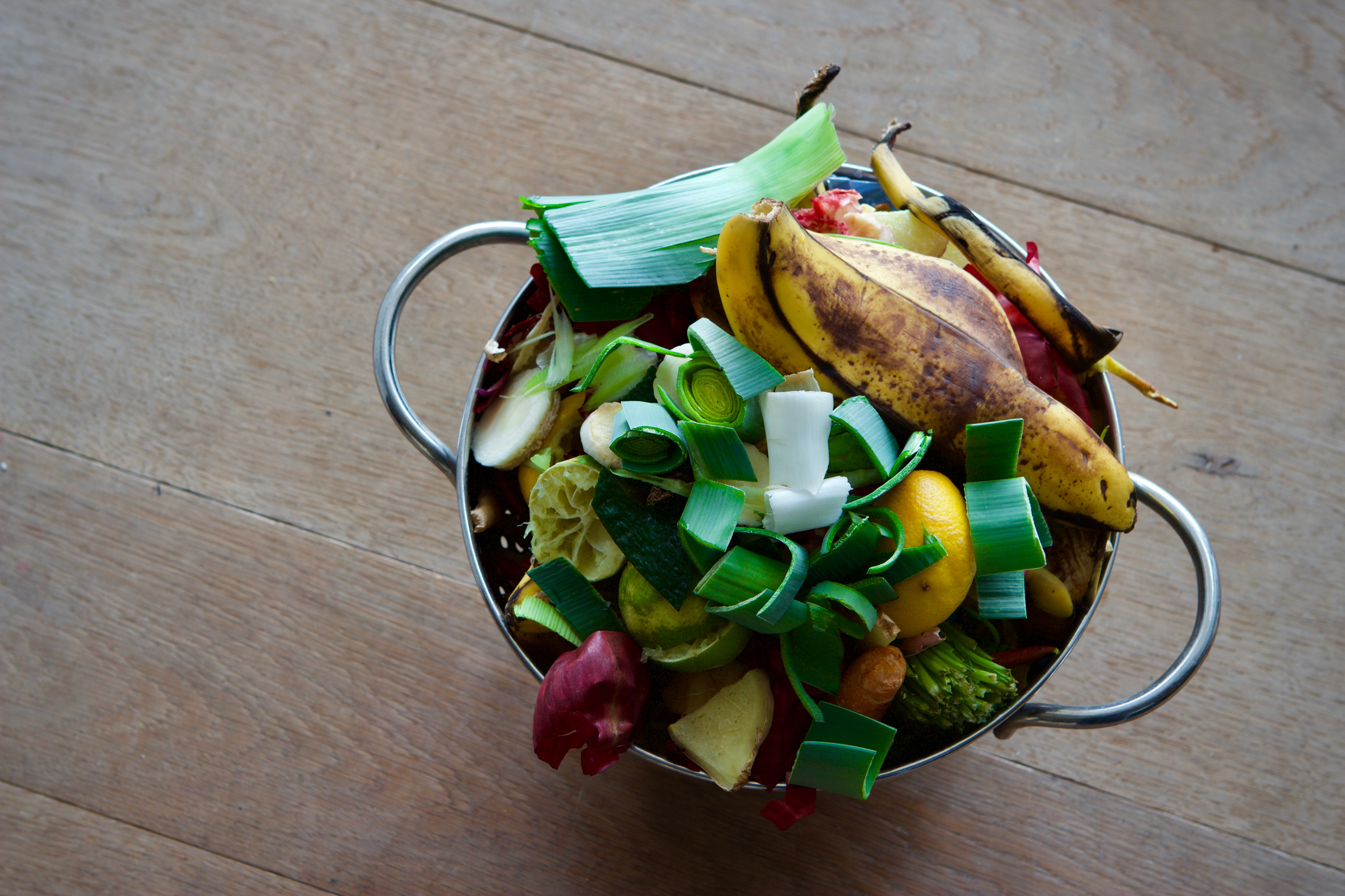 Small kitchen compost bin stuffed with food scraps