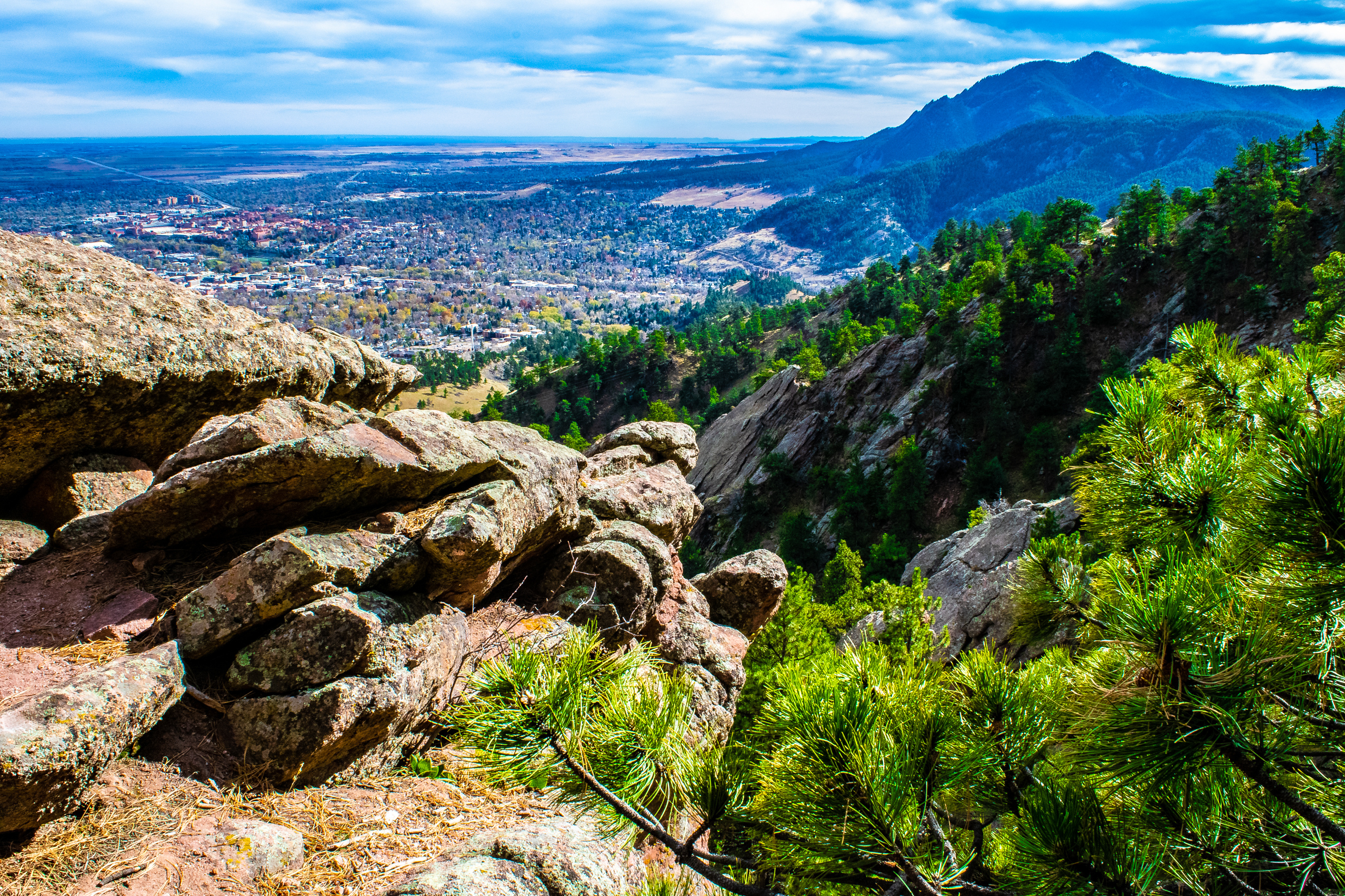 view from mountaintop overlooking boulder colorado with spring greenery