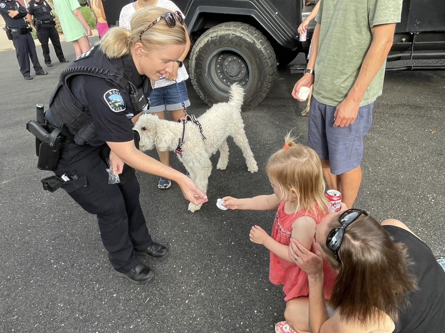 Officer Hickam giving a sticker to a child