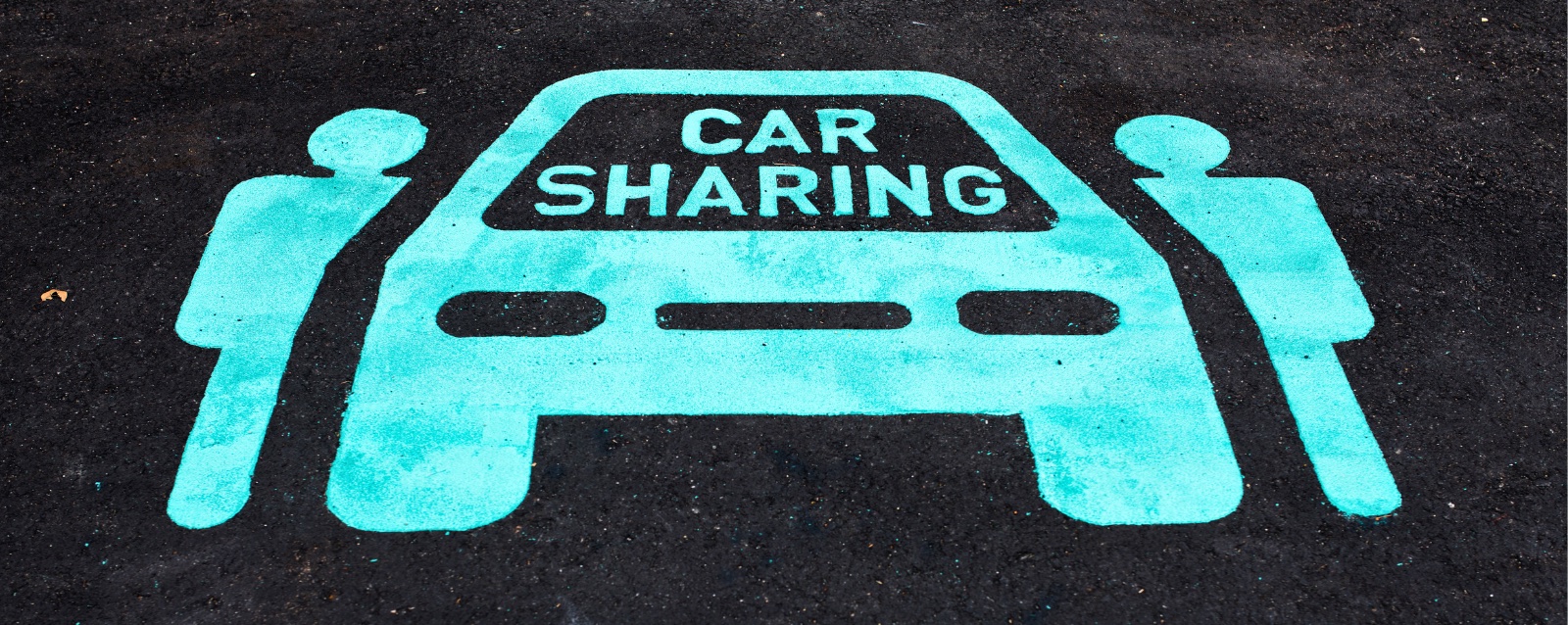 Two people and a car painted on asphalt signifying a car share vehicle