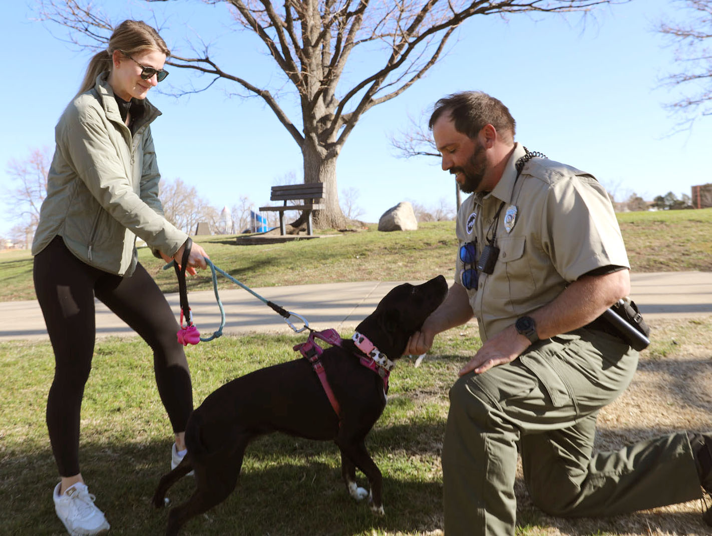 Urban Park Ranger meeting a community member and her dog, Luna