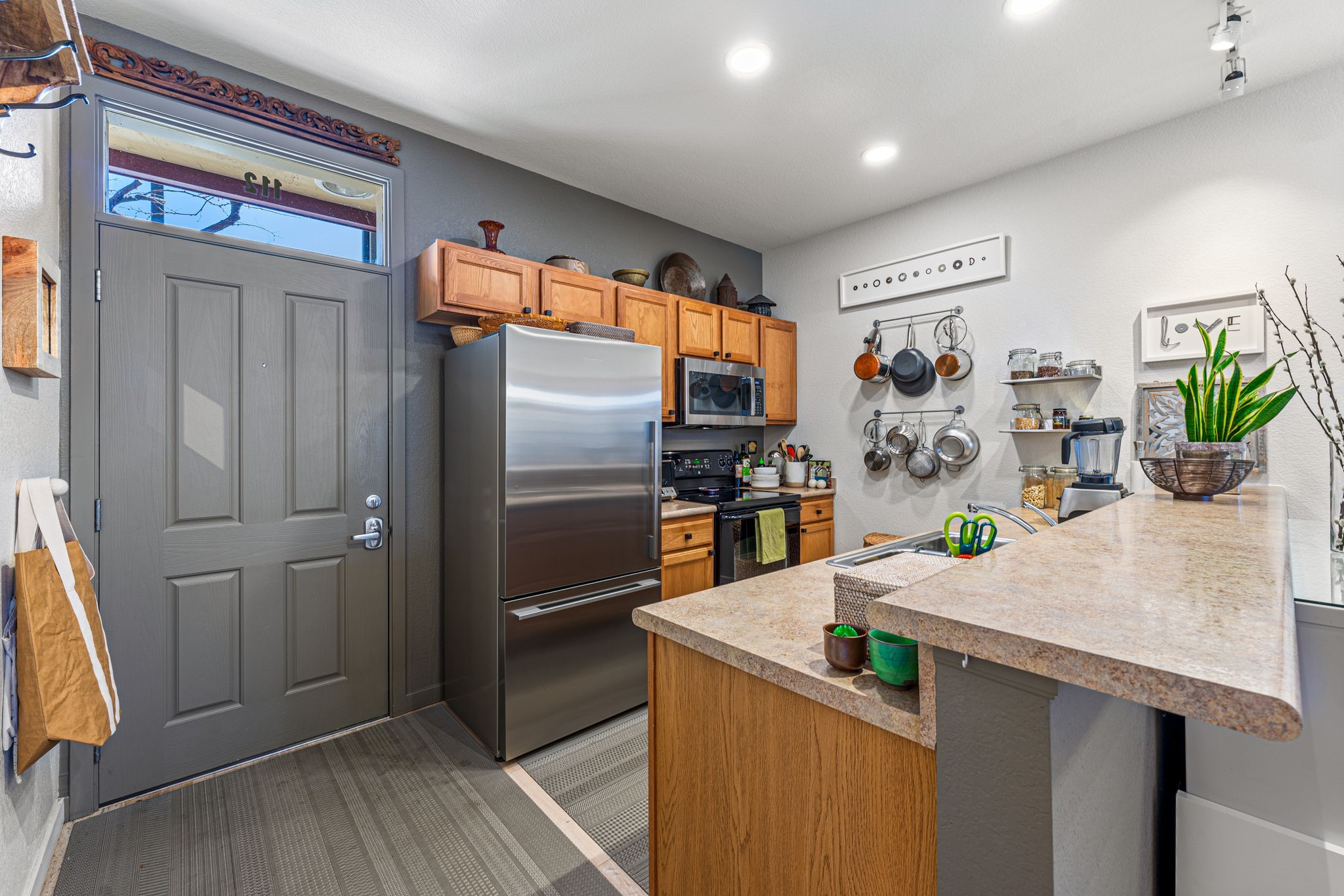 Kitchen side view facing pantry and fridge
