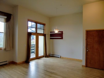 Livingroom view looking at large tall sliding glass door