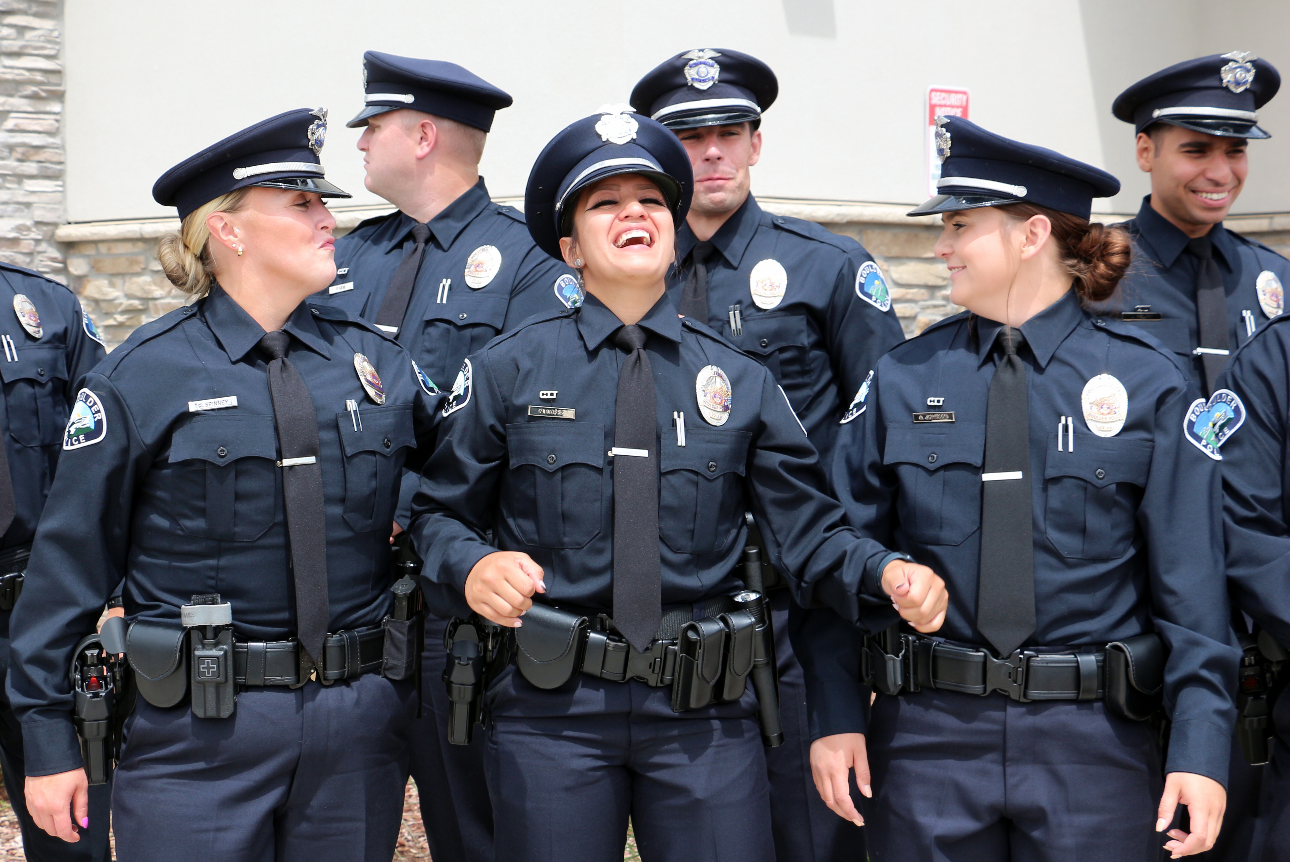 A group of Boulder Police Officers posing for a photo laughing. 