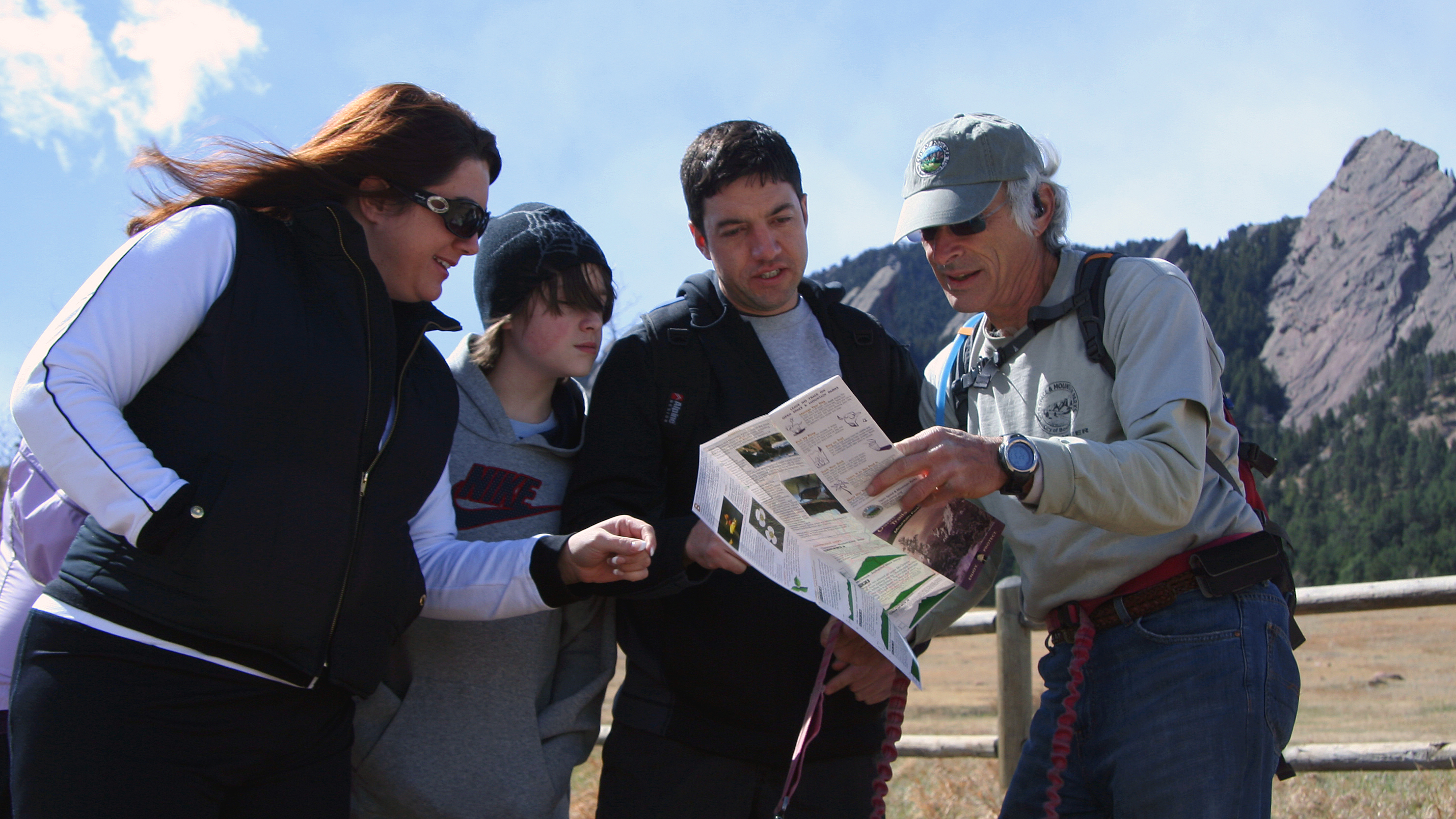 A OSMP trail ambassador helps visitors in the Chautauqua Meadow