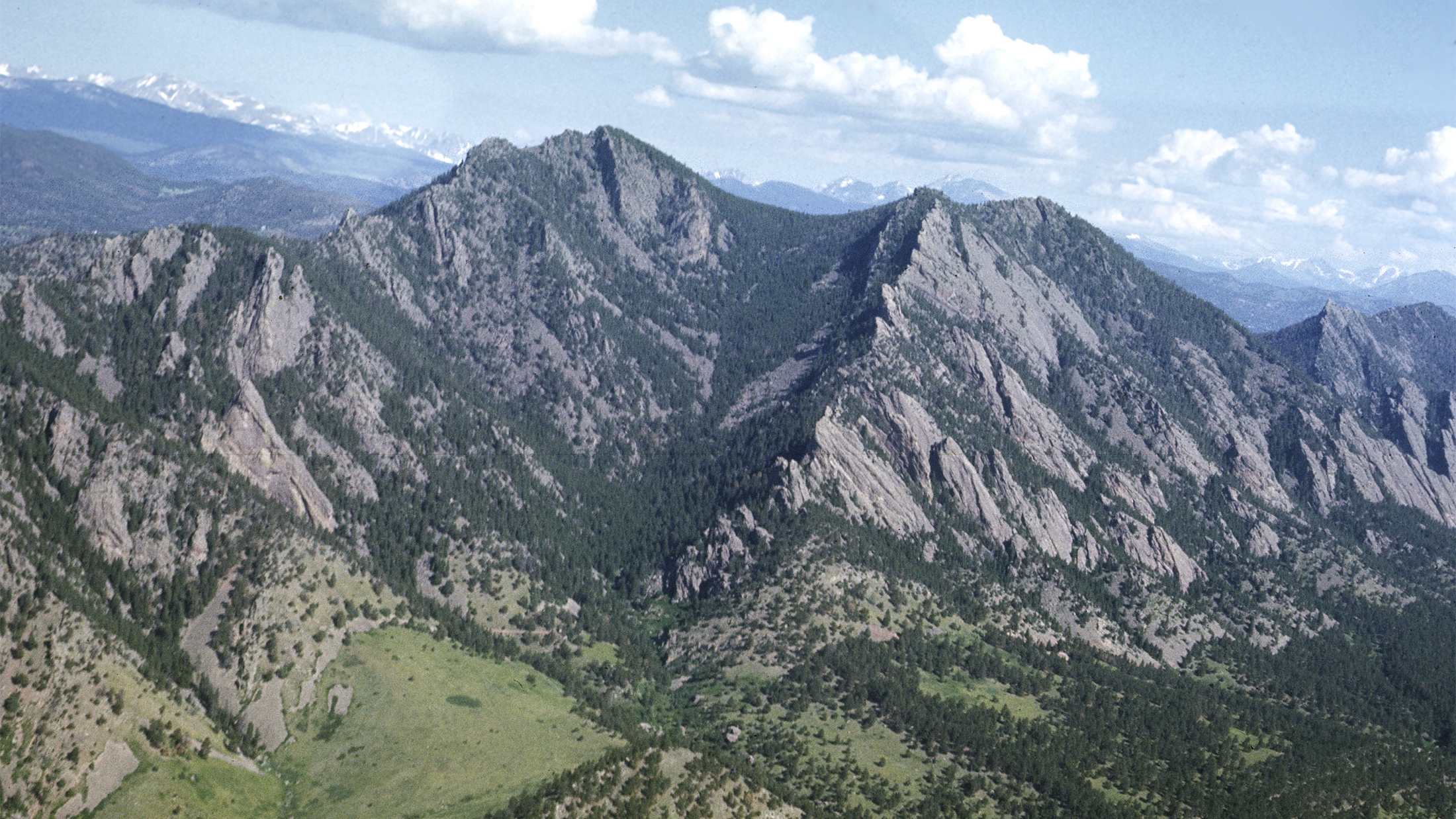 The Boulder Flatirons and the mountain backdrop as seen from an airplane.