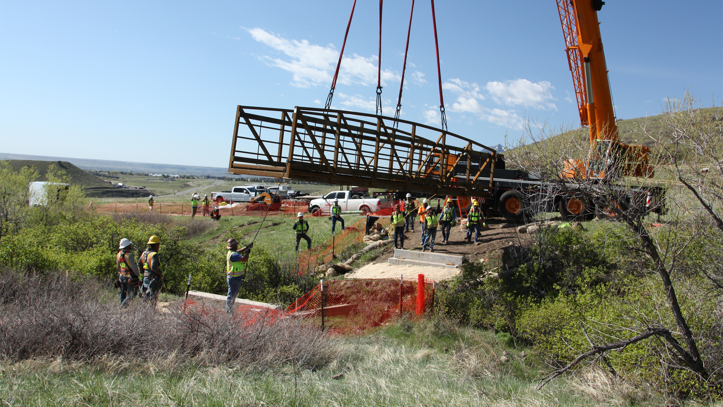 Construction crews work to install a new bridge for the new North Sky Trail.