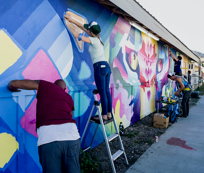 Artist working on a mural. 