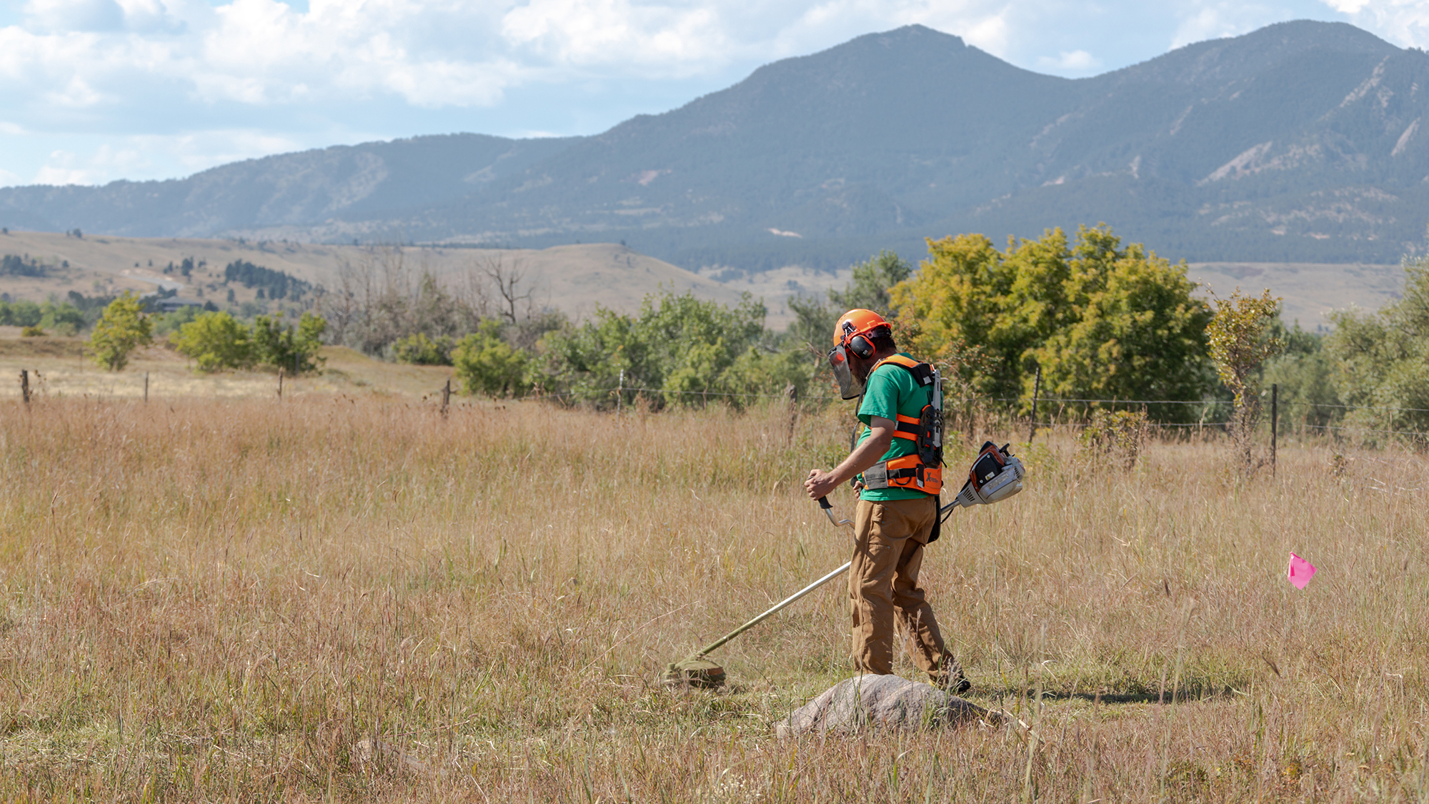 Crew mows on open space