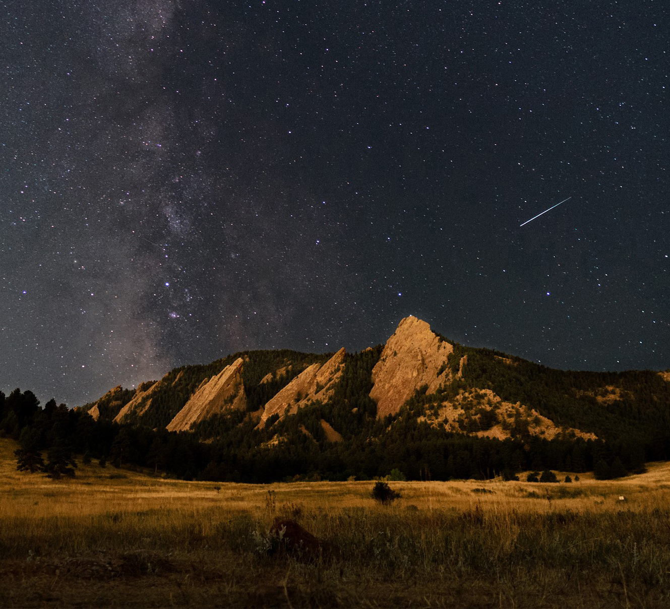 Stars shine over the Boulder Flatirons