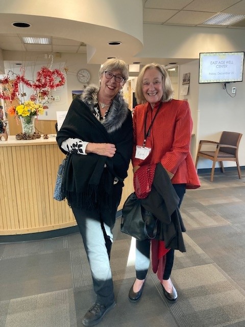 Two well-dressed women smile excitedly before visiting Cherokee Ranch and Castle for high tea.