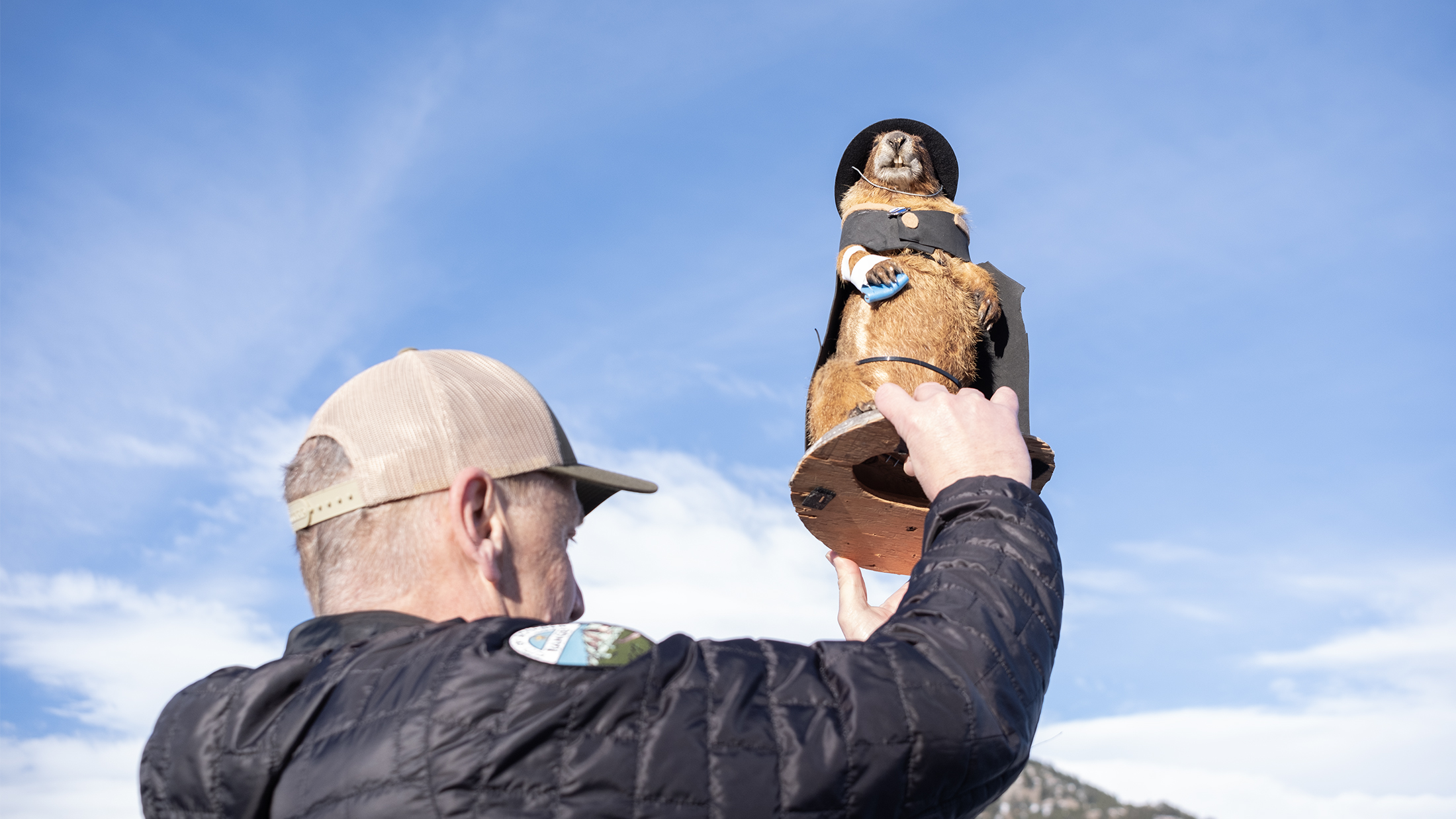 An OSMP Ranger holds Flatiron Freddy in the Chautauqua Meadow