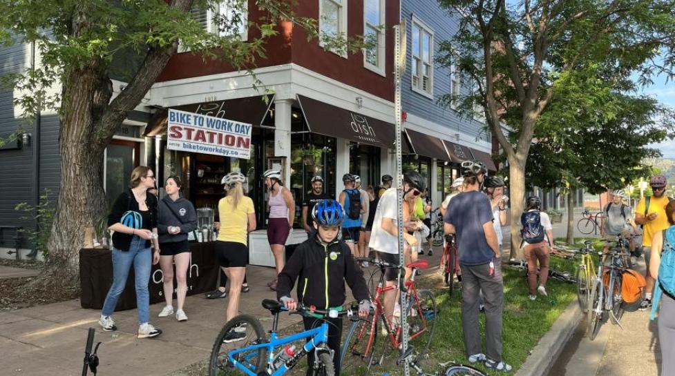 Community members and their bikes at a Bike to Work Day station