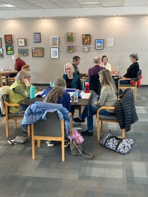 In this picture are several tables of four people playing mahjongg and other games at the East Age Well Center.