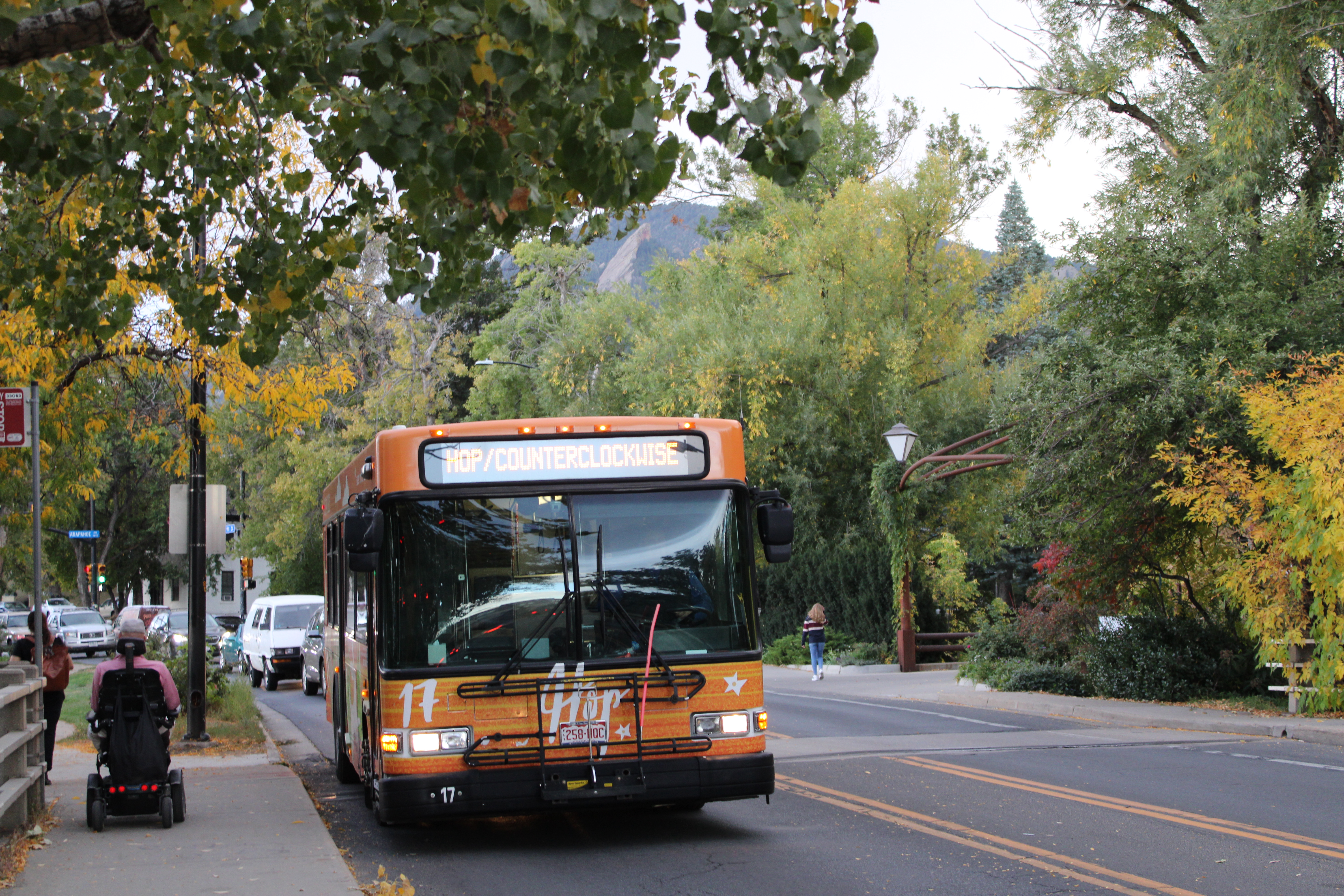 9th Street HOP Bus at bus stop as person in wheelchair boards