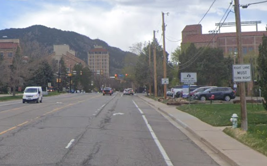 Colorado Avenue shown before 2025 mobility enhancements with one vehicle through-lane, one vehicle right-turn lane, and a 6-foot-wide bike lane, separated from the vehicle lanes by a painted stripe. 