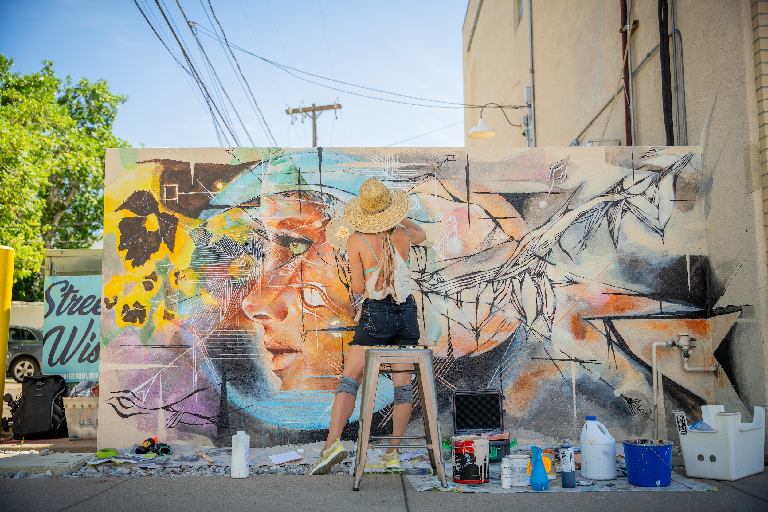 Person painting a mural. 