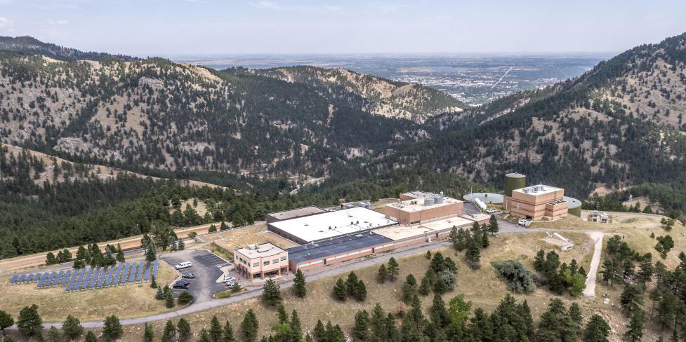 Aerial view of a water treatment plant in a mountainous area. 