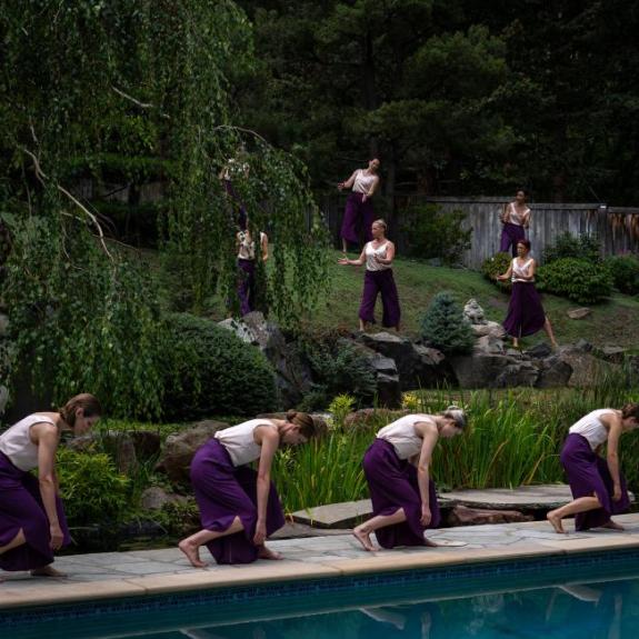 Contemporary dancers performing in an outside venue