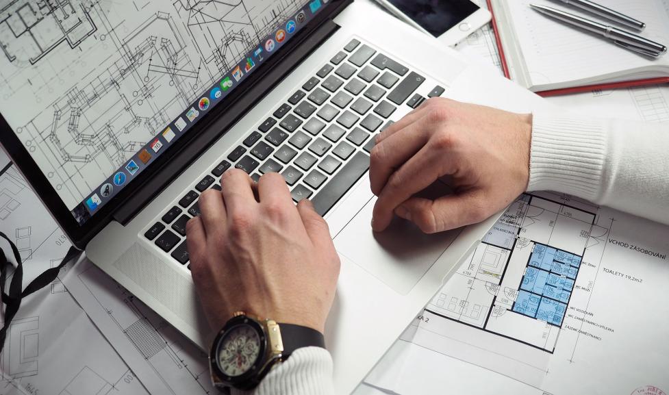 Laptop with architectural blueprints
