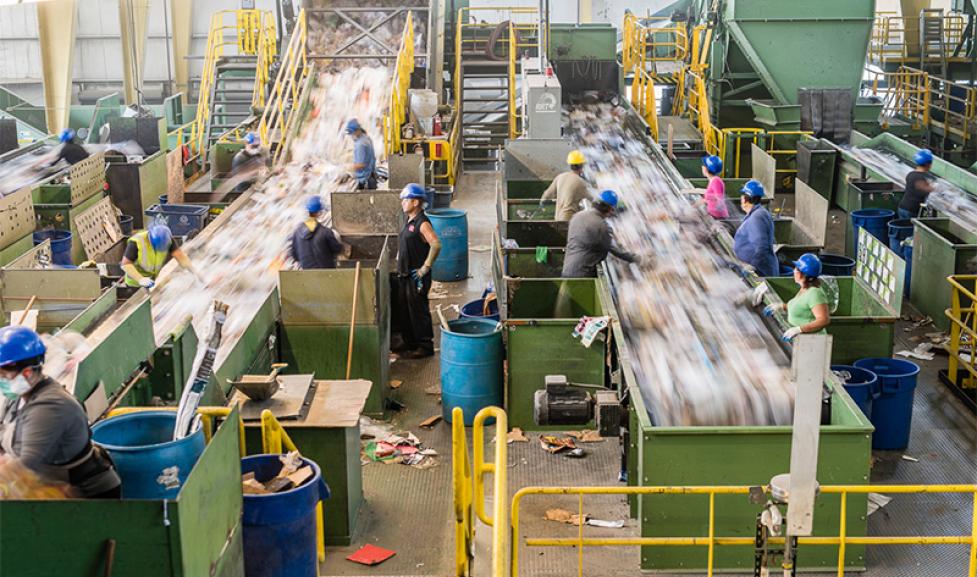Workers at the Boulder County Recycling Center sort recyclable waste