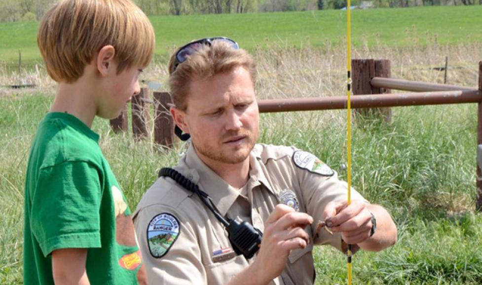 Ranger helping child fish