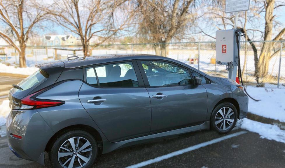 A grey Nissan Leaf is plugged into a bi-directional charger at the North Boulder Recreation Center