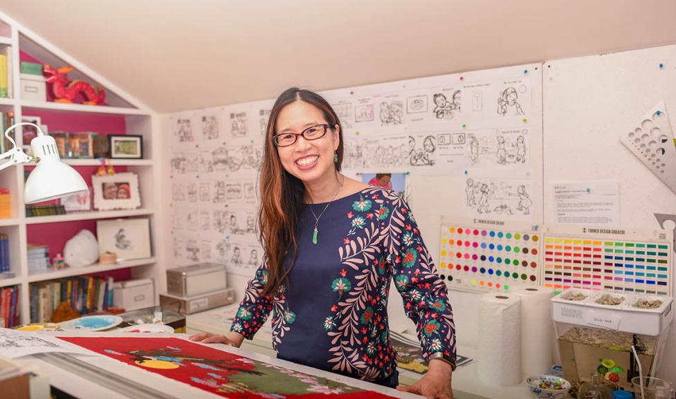 Author Grace Lin smiles in her colorful studio. 