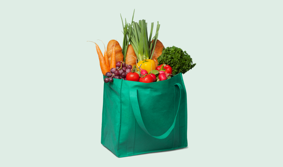 Reusable grocery bag filled with produce