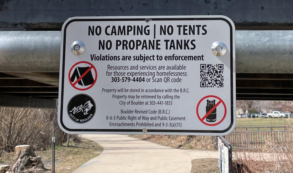 Public sign: No camping, no tents, no propane tanks. Violations are subject to enforcement. 
