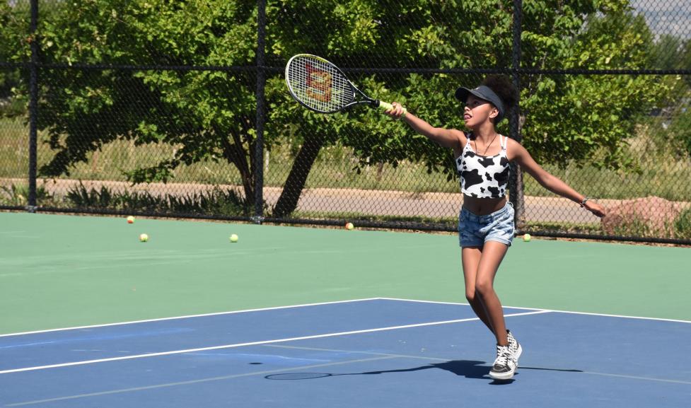 Kid playing tennis at the East Boulder Community Park tennis courts