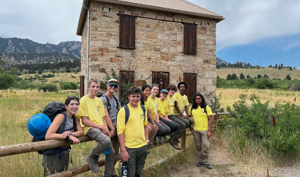 Junior Ranger Crew poses by historic homestead at South Mesa