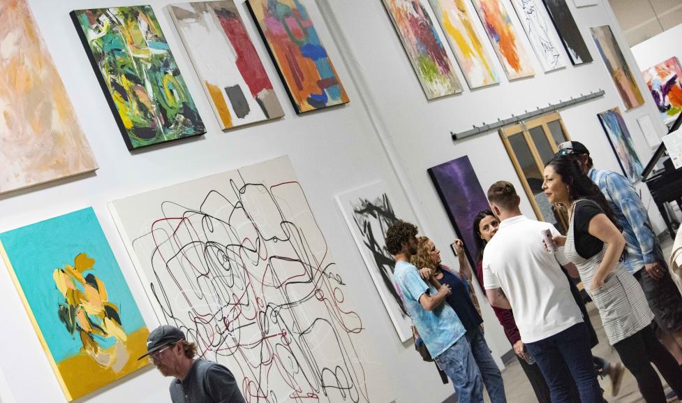 Art gallery exhibition filled with attendees