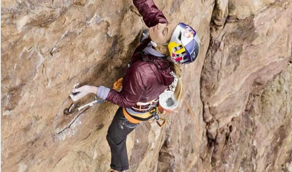 Looking down from above at two women climbers on a rock face.