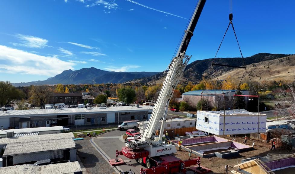 Crane lifts section of the first BoulderMOD built duplex onto the foundation at Ponderosa Mobile Home Park. 