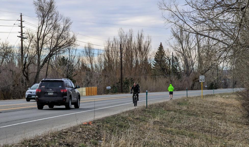 people biking and walking on 28th Street (US 36) roadway shoulder