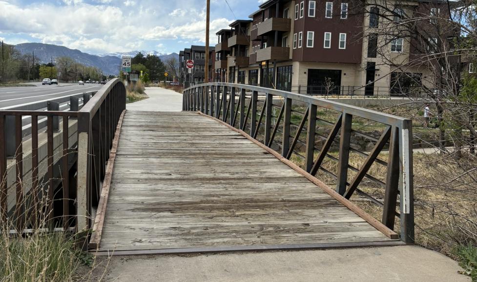 wooden deck bridge to concrete path