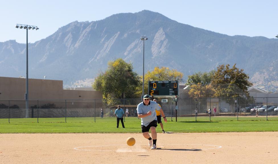 This image displays kickball play at East Mapleton