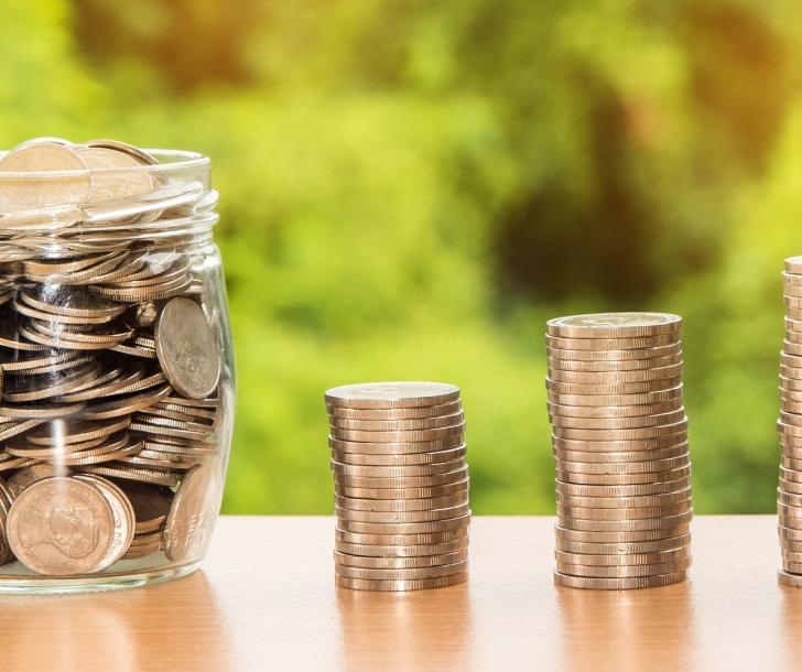 Coins stacked and in a jar