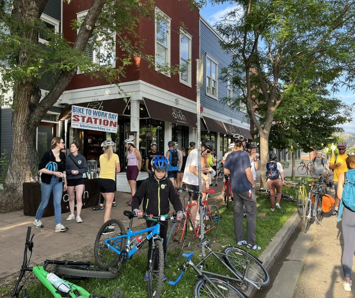 People and bikes gathered outside a breakfast station on Bike to Work Day