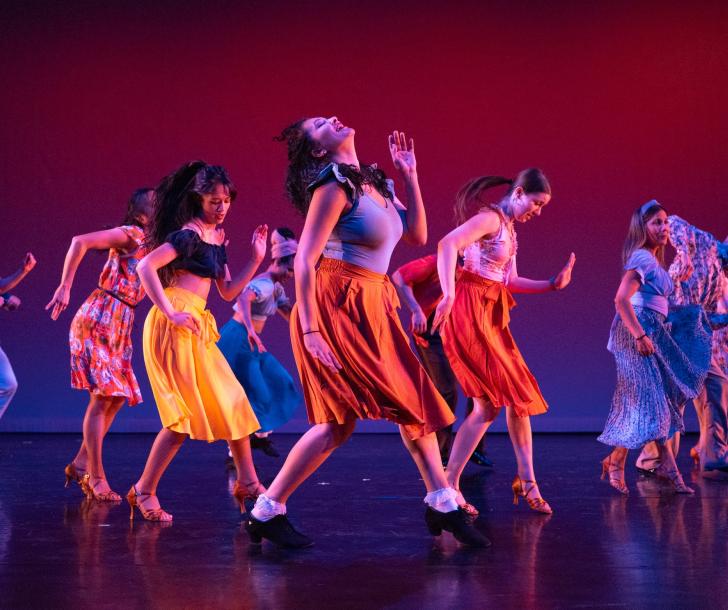 Dancers in colorful outfits performing on stage
