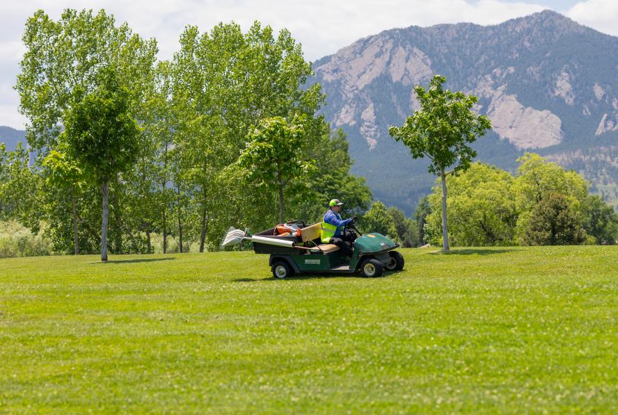 Park maintenance staff with the Boulder Flatirons in the background