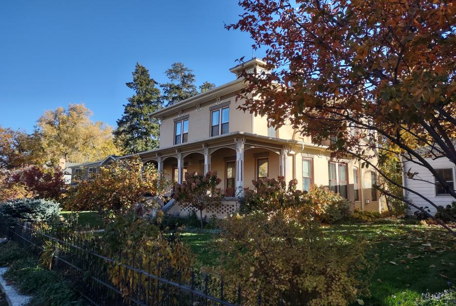 Historic house (Hannah Barker House at 800 Arapahoe Ave.) surrounded by trees in the autumn.