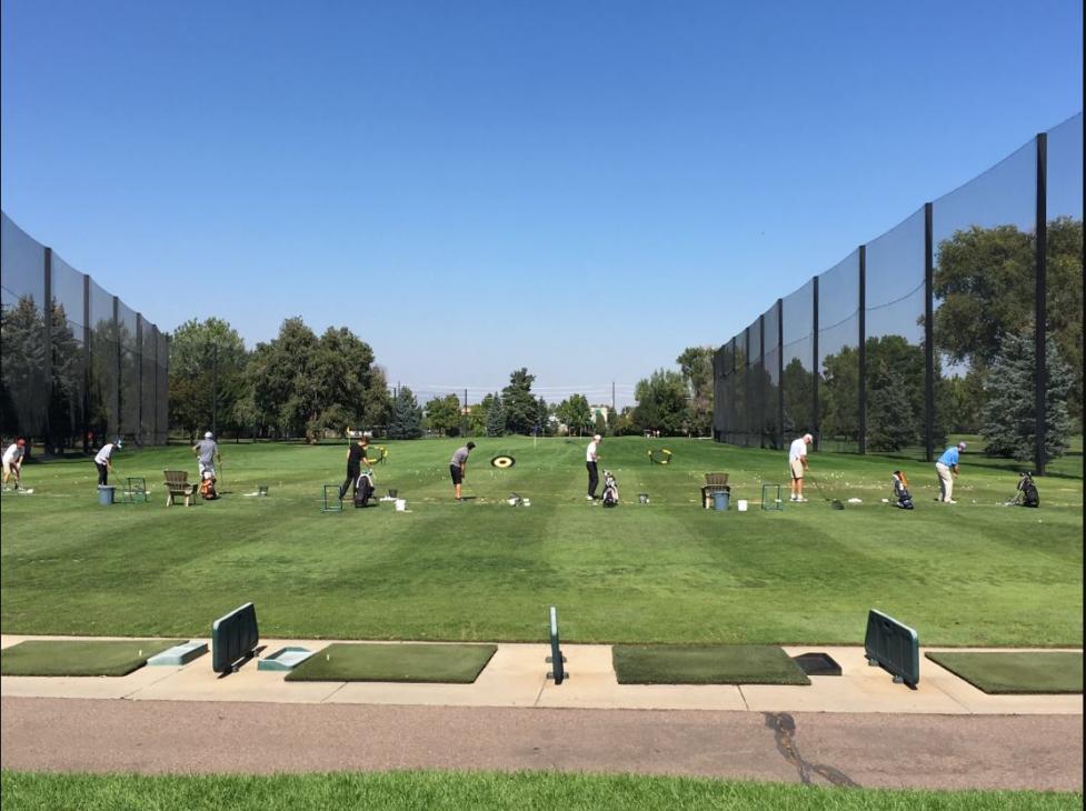 Golfers practicing at the Flatirons Golf Course driving range